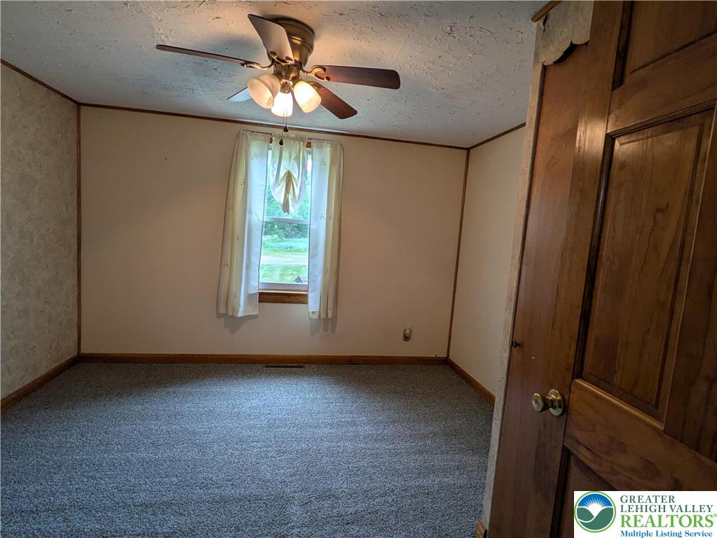 124 Sterling Valley Road Kunkletown, PA 18058 - Photo 25 of 29 an empty room with windows and fan