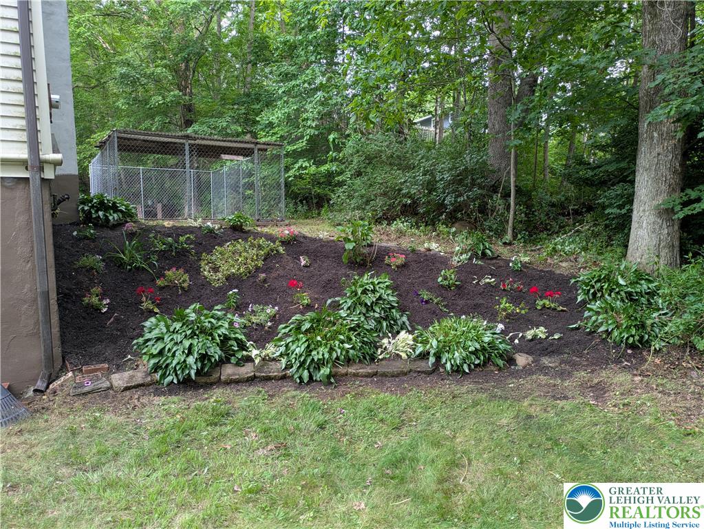 124 Sterling Valley Road Kunkletown, PA 18058 - Photo 27 of 29 a view of a garden with plants and large trees