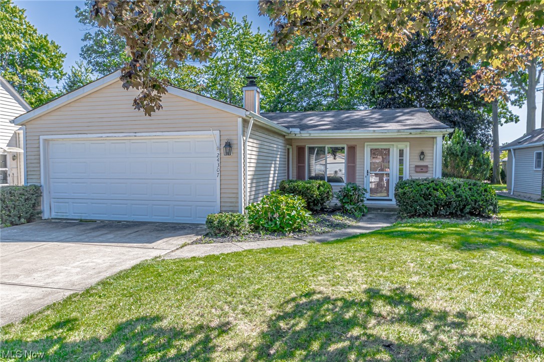 Single story home with a front yard and garage