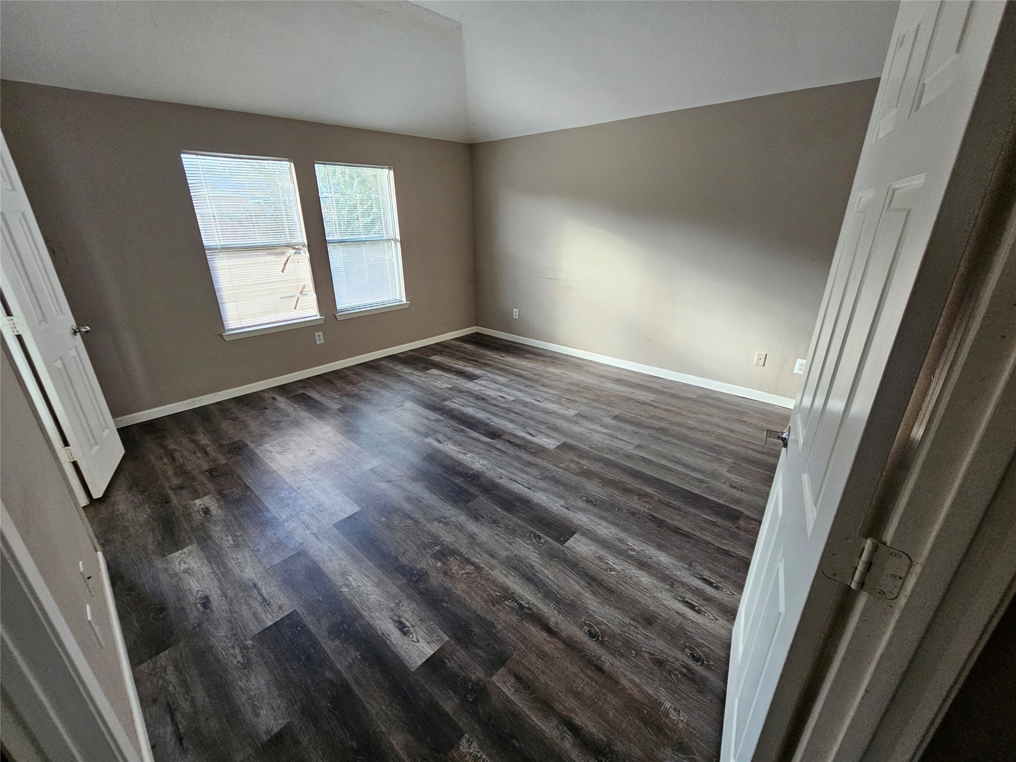 6319 Nullarbor Court Katy, TX 77449 - Photo 11 of 24 an empty room with wooden floor and windows