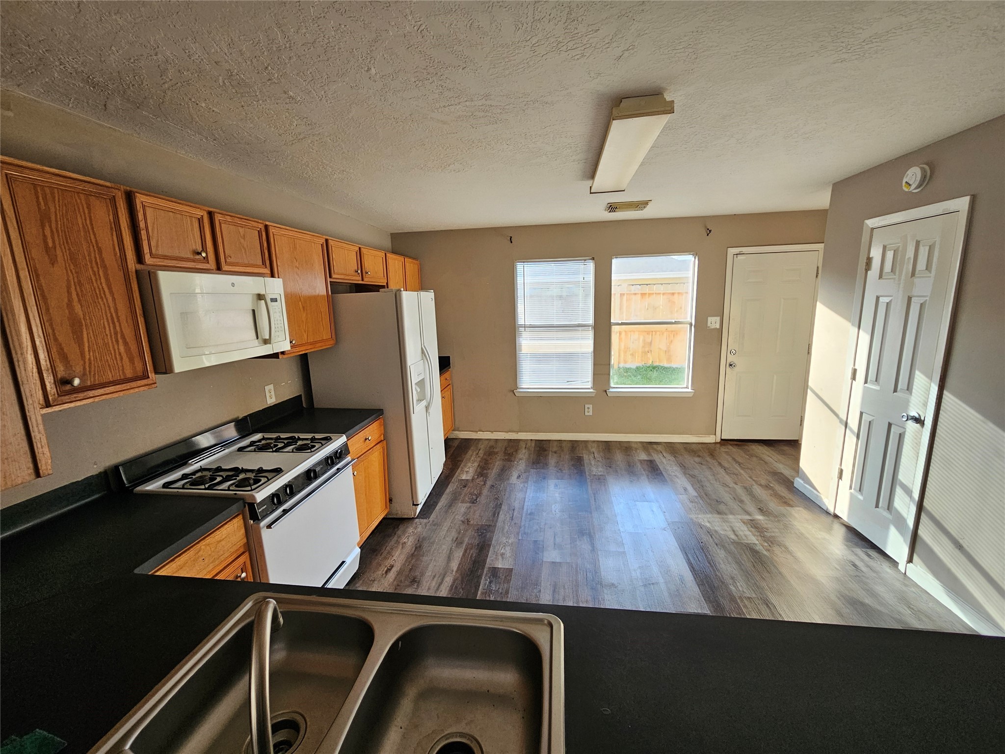 6319 Nullarbor Court Katy, TX 77449 - Photo 8 of 24 a view of a kitchen with wooden floor and black appliances
