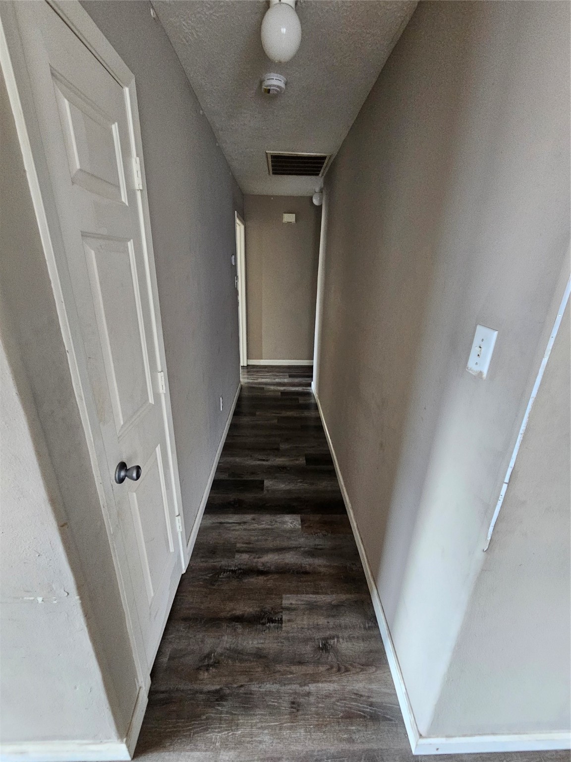 6319 Nullarbor Court Katy, TX 77449 - Photo 10 of 24 a view of a hallway with wooden floor and staircase