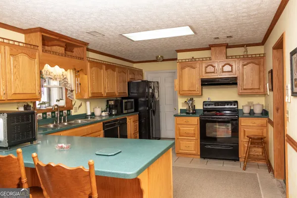 a kitchen with stainless steel appliances granite countertop a refrigerator and a stove