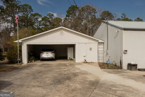 a view of a house with a yard and garage