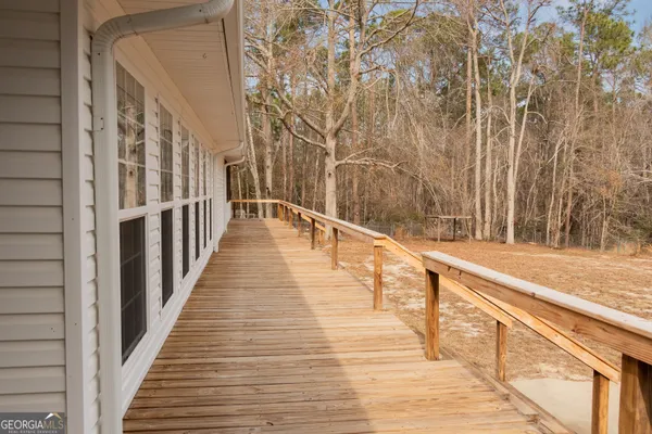 a view of balcony with wooden floor and fence