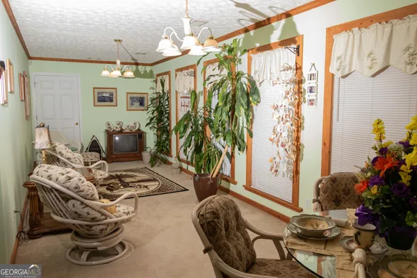 a living room with furniture and flowers