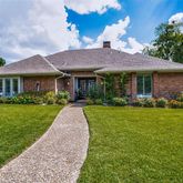 a front view of a house with a yard table and chairs