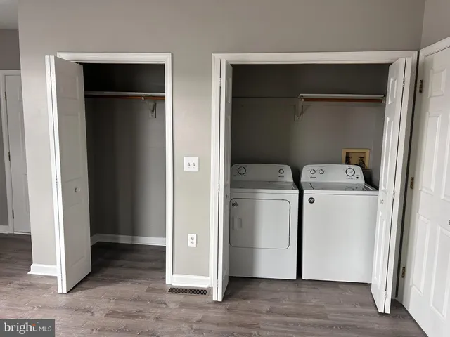 a utility room with cabinets washer and dryer