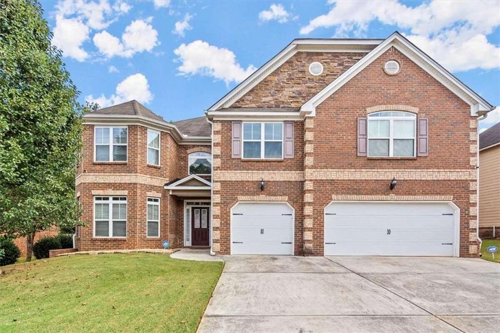 135 Riverstone Drive Covington, GA 30014 - Photo 1 of 1 a front view of a house with a yard