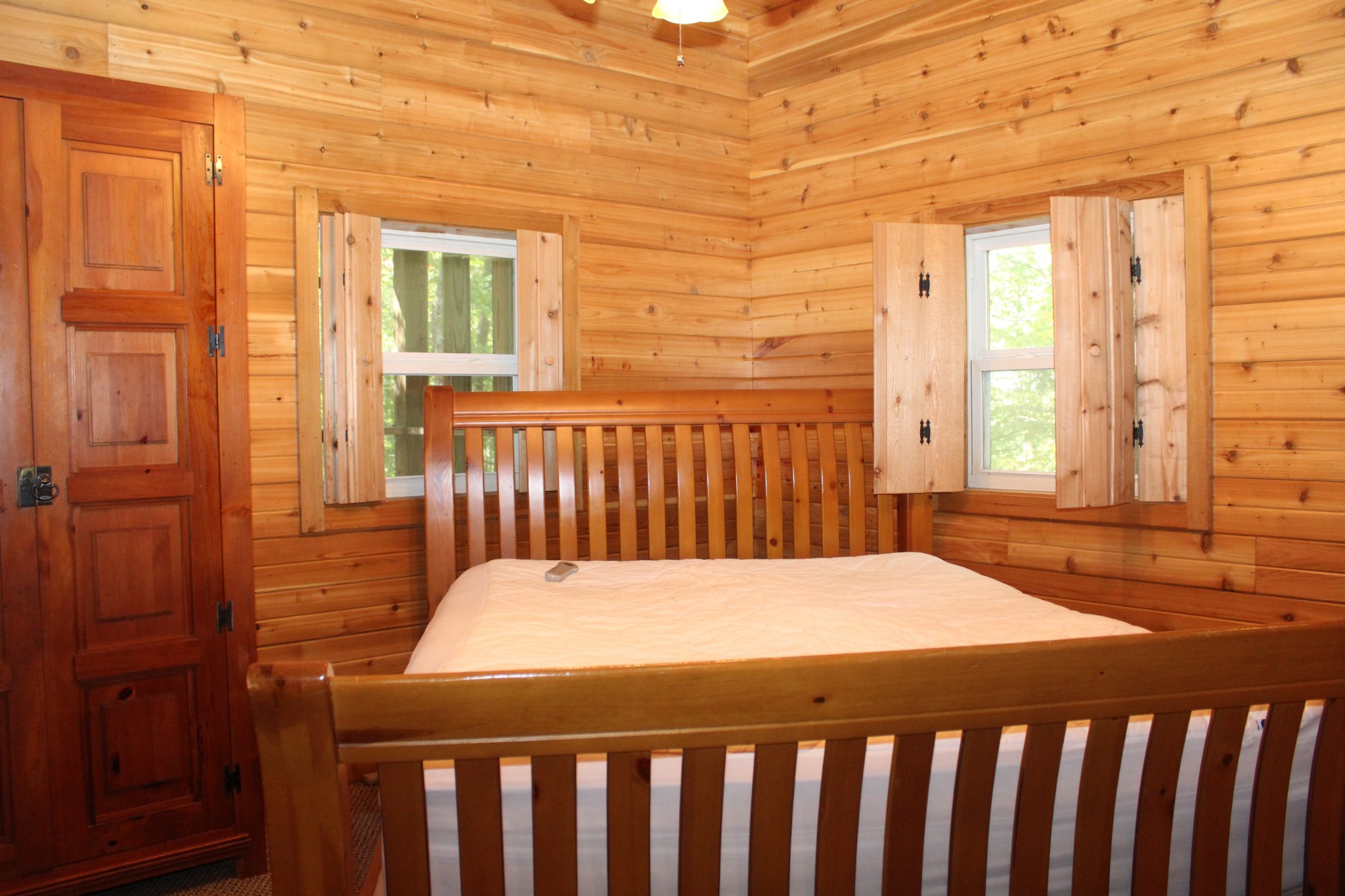 249 Claude Fox Road Lafayette, TN 37083 - Photo 49 of 68 a bedroom with a bed and wooden floor