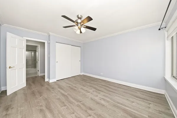 a view of a room with wooden floor and window