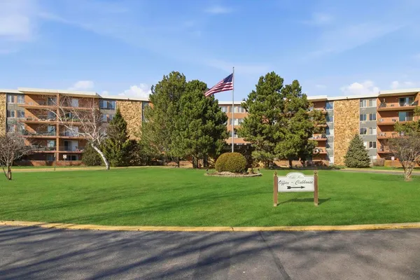a front view of a multi story building with yard