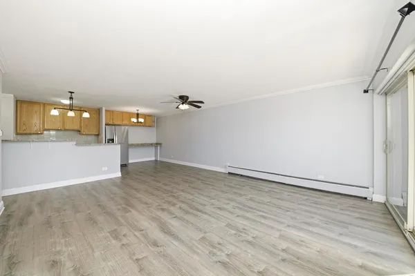 a view of a room with wooden floor and a window
