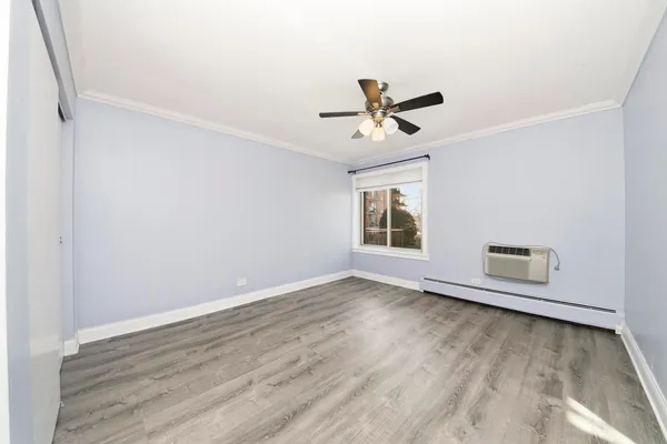 a view of room with hardwood floor and ceiling fan