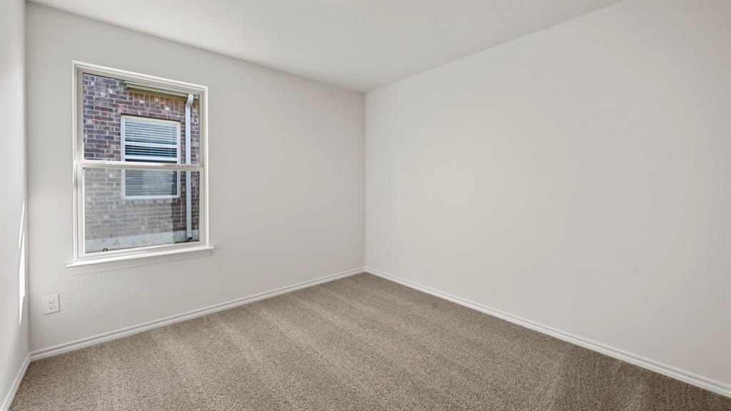 1663 Blaire Drive Tyler, TX 75704 - Photo 22 of 26 Room featuring neutral-toned carpeting and light-colored walls