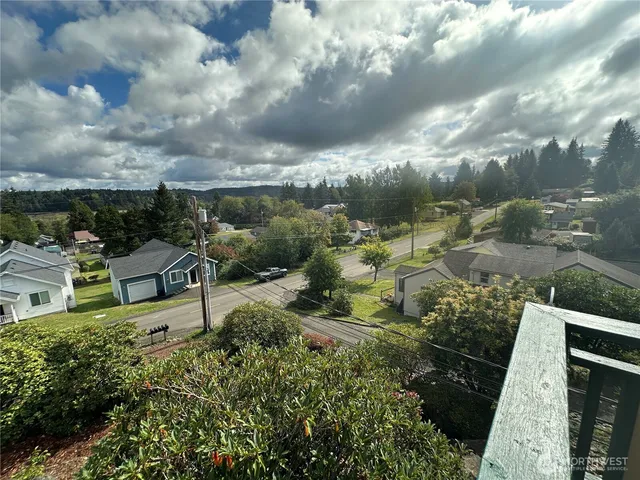 an aerial view of residential house with green space