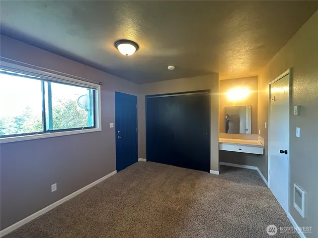 an empty room with windows and entrance