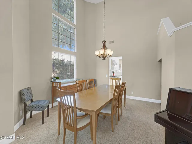 a view of a dining room with furniture and chandelier