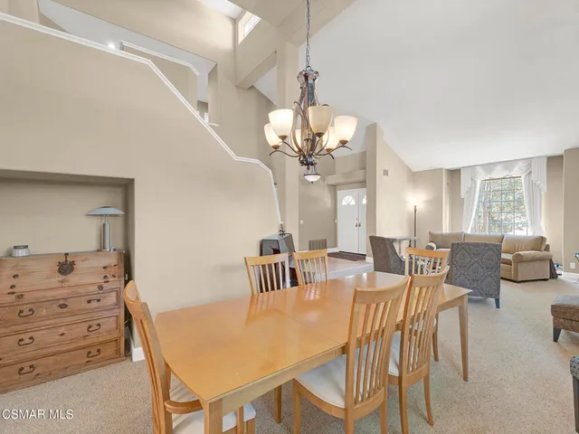 a view of a dining room with furniture and chandelier