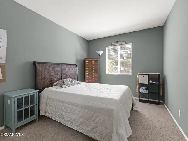 a bedroom with a large bed and a closet