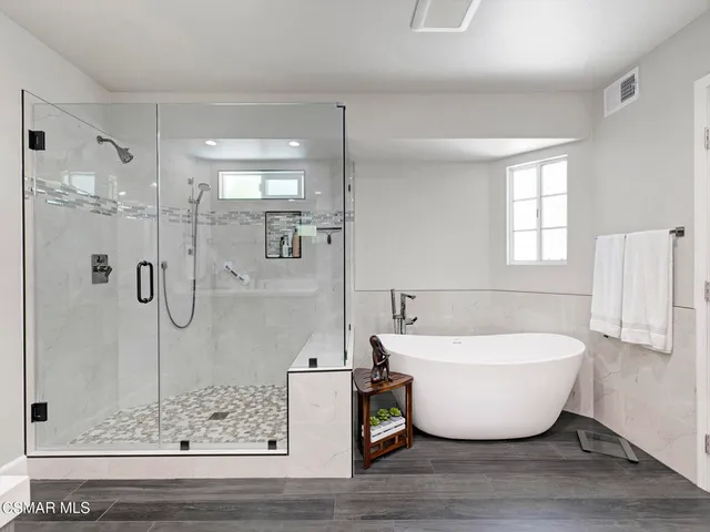 a view of a bathroom with a bathtub and shower