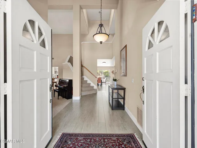 a view of a hallway to a livingroom and a couch