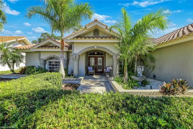 a front view of a house with garden