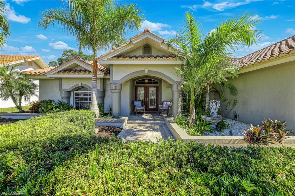 146 Muirfield Circle Naples, FL 34113 - Photo 1 of 31 a front view of a house with garden