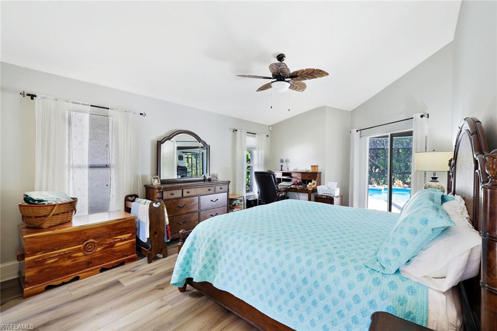 146 Muirfield Circle Naples, FL 34113 - Photo 16 of 31 a bedroom with a bed and wooden floor