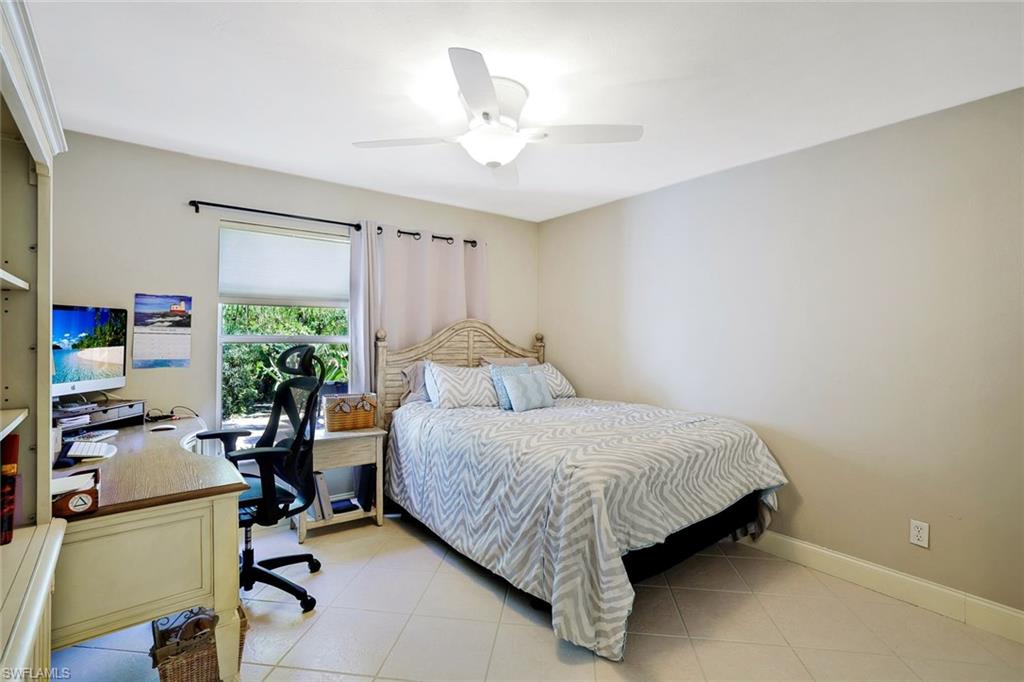 146 Muirfield Circle Naples, FL 34113 - Photo 21 of 31 a bedroom with a bed and a desk