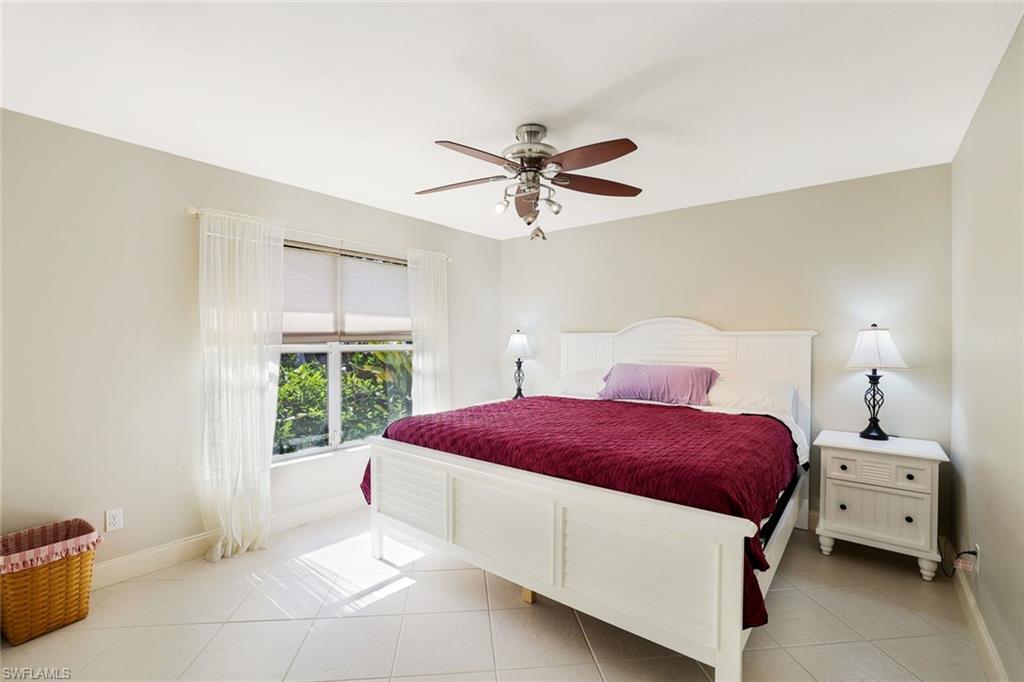 146 Muirfield Circle Naples, FL 34113 - Photo 23 of 31 a living room with a bed and a window