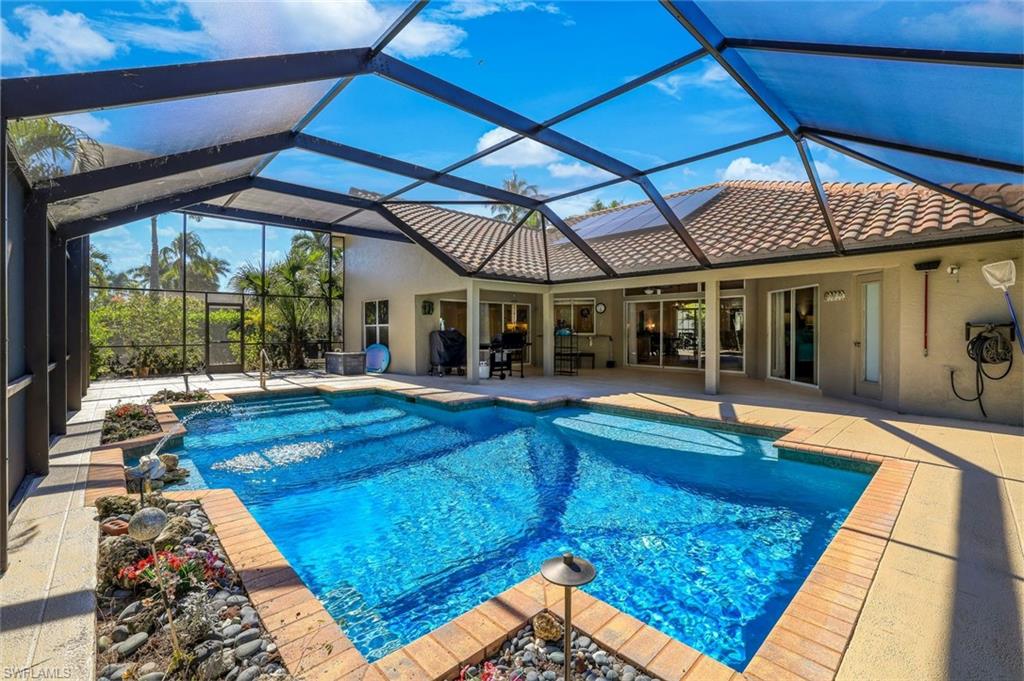 146 Muirfield Circle Naples, FL 34113 - Photo 28 of 31 a view of a backyard with swimming pool
