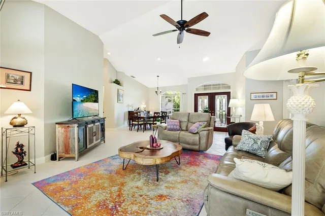 a living room with fireplace furniture and a rug