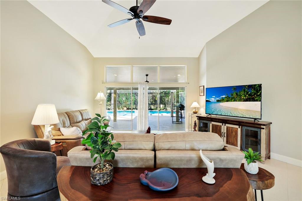 146 Muirfield Circle Naples, FL 34113 - Photo 8 of 31 a living room with furniture and a flat screen tv