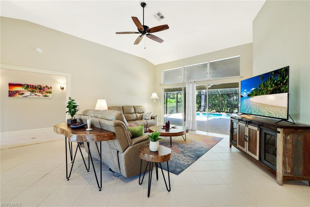 146 Muirfield Circle Naples, FL 34113 - Photo 9 of 31 a living room with furniture a ceiling fan and a flat screen tv