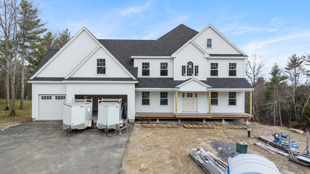 30 Highclere Road Windham, NH 03087 - Photo 6 of 6 a view of a white house with large windows and a large tree