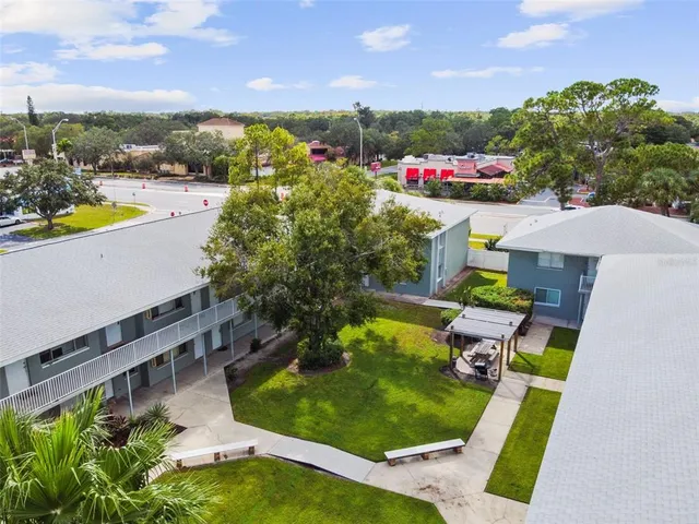 a view of a swimming pool with a patio and a yard