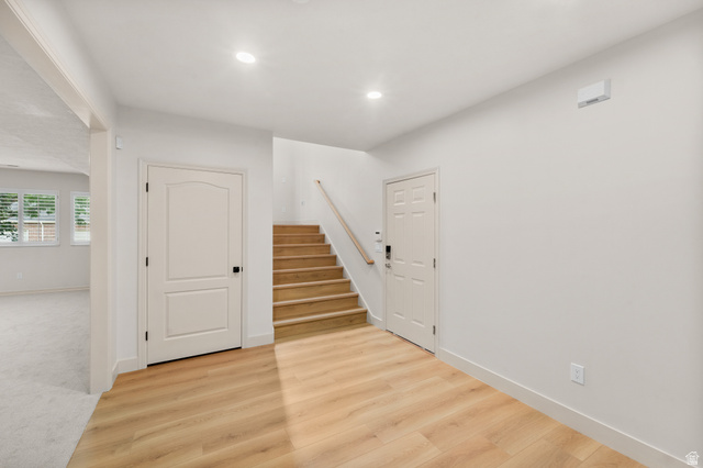 340 Brayden Way Draper, UT 84020 - Photo 44 of 58 Wood-finish flooring, recessed lighting, light wood staircase, white interior doors, and neutral wall tones