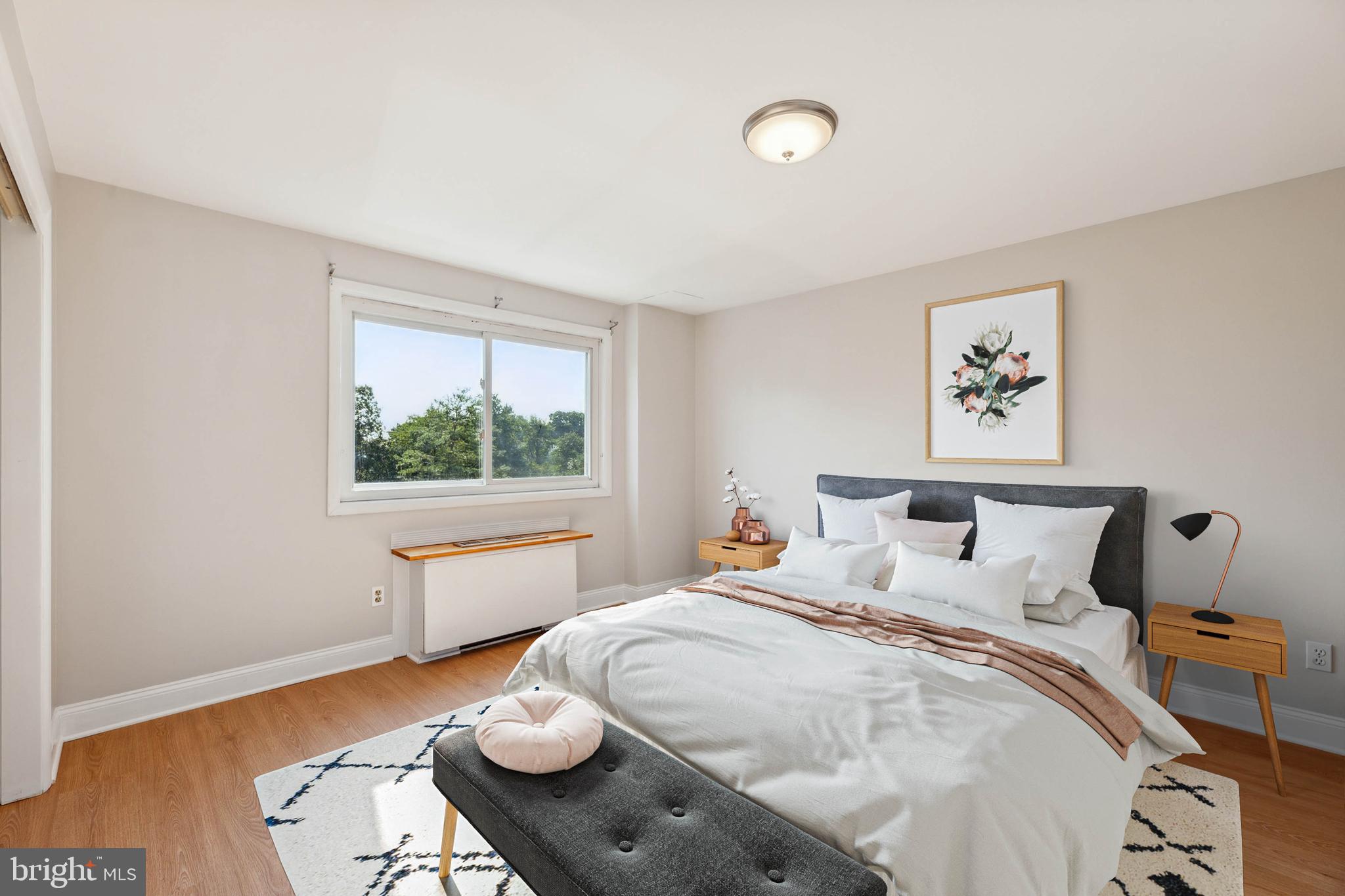 5101 8th Road South, Unit 310 Arlington, VA 22204 - Photo 16 of 28 a bedroom with a bed and wooden floor