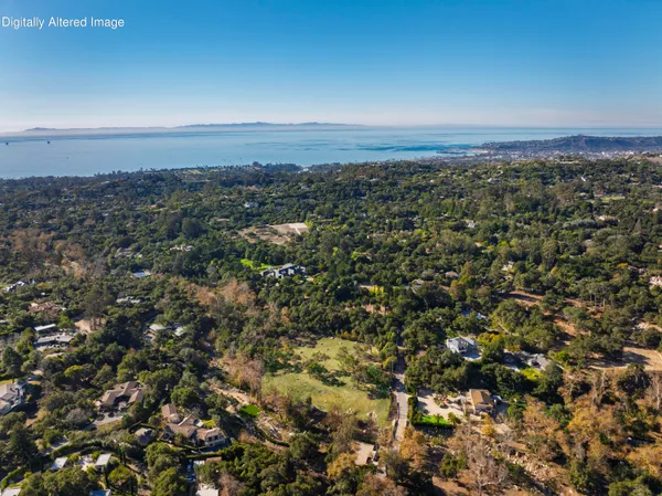an aerial view of residential building and green space