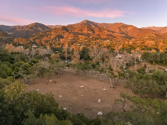 a view of a town with mountains in the background