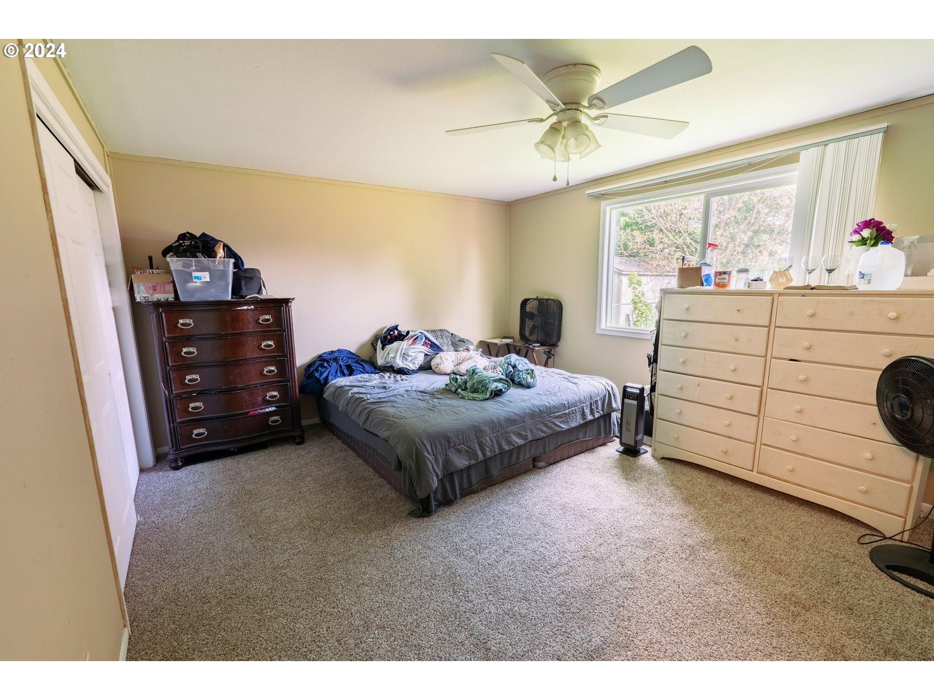 9111 Northeast 73rd Street Vancouver, WA 98662 - Photo 19 of 33 a bedroom with a bed and a ceiling fan