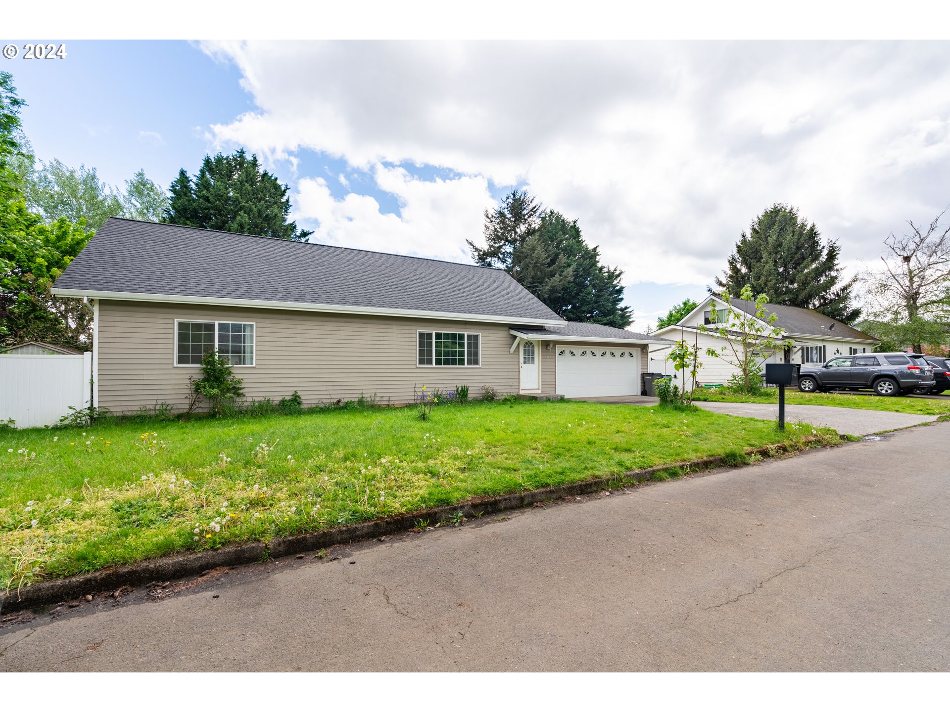 9111 Northeast 73rd Street Vancouver, WA 98662 - Photo 5 of 33 a view of a house with a yard and table and chairs under an umbrella