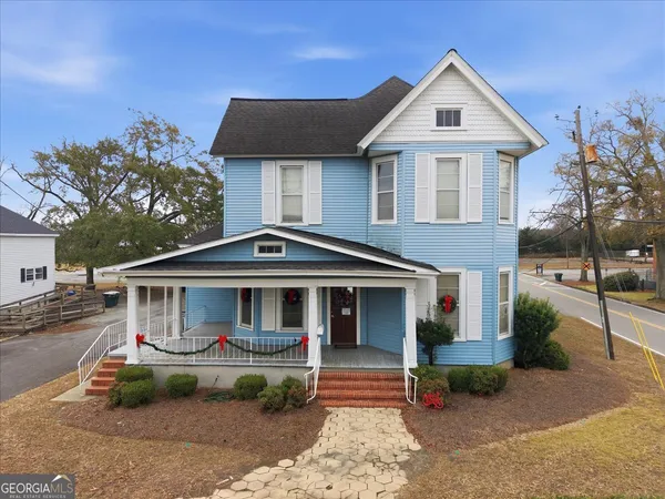 a front view of a house with a garden