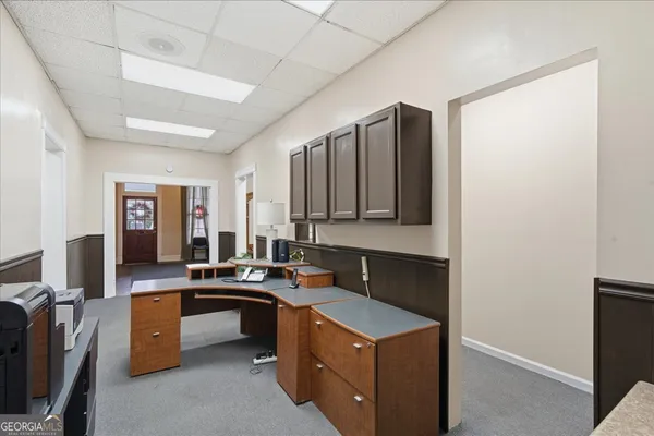 a living room with furniture a fireplace and gym equipment