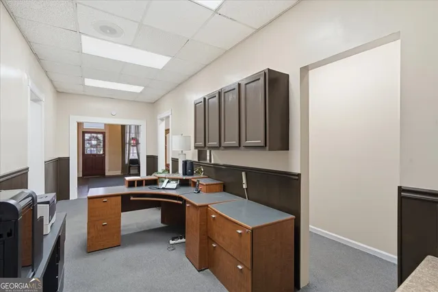a living room with furniture a fireplace and gym equipment