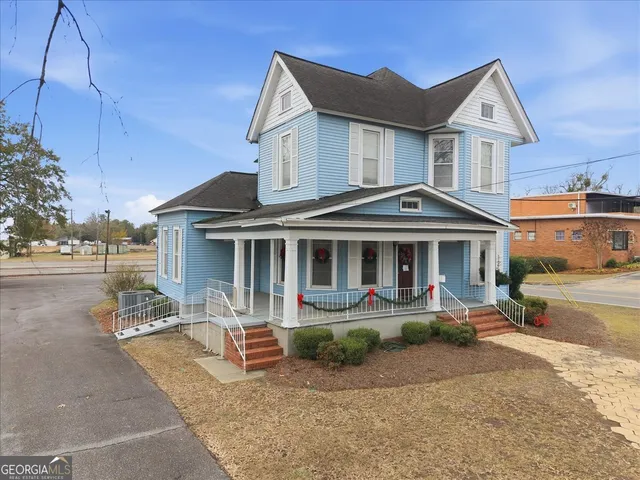 a view of a livingroom with couch and a workspace