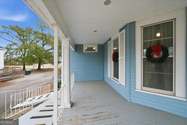 a view of a livingroom with lounge chair and a ceiling fan