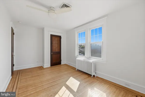 a view of a livingroom with wooden floor and a window