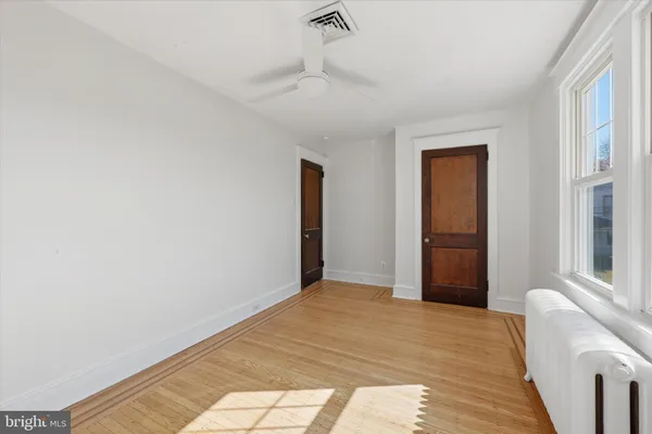 an empty room with closet and windows